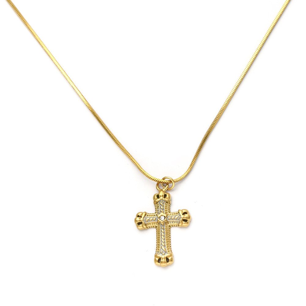 Gold cross necklace on a white background